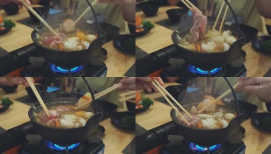 一家人在日本餐馆吃涮涮锅晚餐。和家人一起吃涮锅饭。高清在线视频素材下载