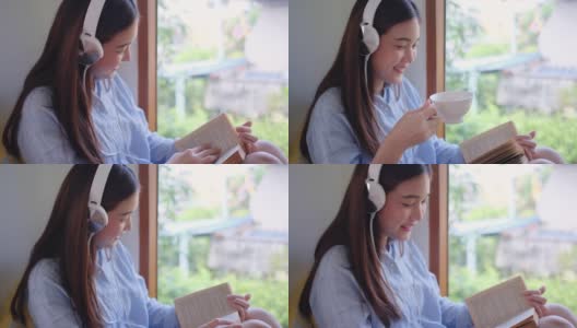 靠近可爱的女孩戴着耳机读一些书，坐在玻璃窗前看起来她有幸福的情绪高清在线视频素材下载
