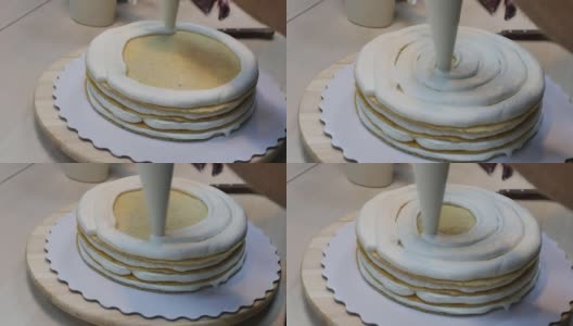 在多层蛋糕中的海绵蛋糕上涂一层厚厚的奶油高清在线视频素材下载