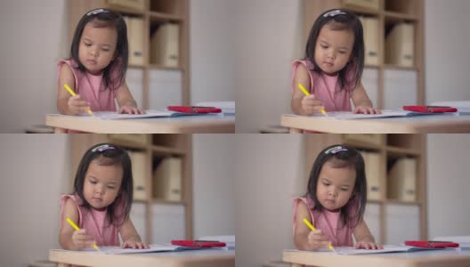 亚洲小女孩在家里用彩色铅笔涂色练习本学习高清在线视频素材下载