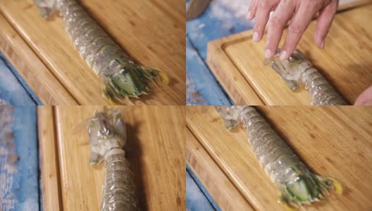 新鲜的螳螂虾在木制砧板上，新鲜的生螳螂虾的特写高清在线视频素材下载