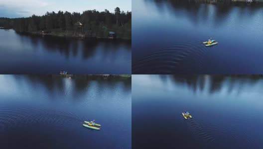 鸟瞰图上的人谁在一个湖上的脚踏双体船，水上自行车高清在线视频素材下载