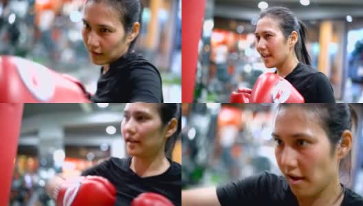 SLO MO亚洲女性在健身房练习泰拳。高清在线视频素材下载