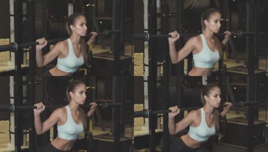 漂亮的年轻女运动员在健身房做下蹲高清在线视频素材下载