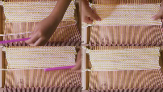小女孩用织布机在家里自制的木架上织毛线高清在线视频素材下载