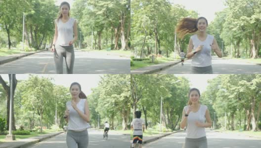 年轻迷人的女人在绿色城市公园跑步锻炼户外健身跟踪可穿戴技术。健身跑步运动的人与健康的生活理念。高清在线视频素材下载