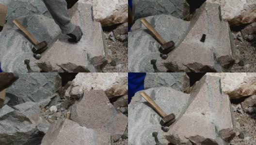 石匠用楔子和大锤切割一块花岗岩高清在线视频素材下载