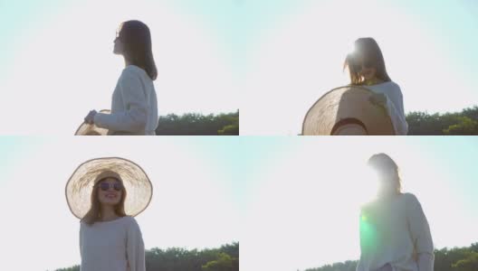 年轻美丽幸福的亚洲女人与帽子和太阳镜肖像微笑和享受阳光在夏日日落。愉快的亚洲女人在自然中放松，并在日落时看别处。高清在线视频素材下载