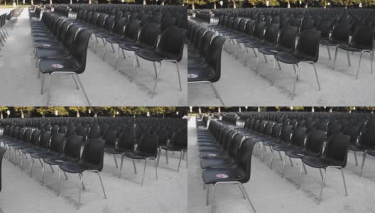 为户外展览准备的一排排空的黑色塑料椅子高清在线视频素材下载