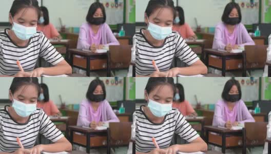 亚洲小学生戴上口罩预防病毒上课开始重开高清在线视频素材下载