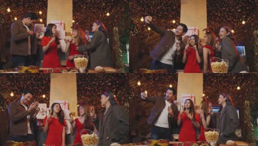 一群朋友庆祝新年倒计时，在晚上拿着香槟酒杯一起自拍高清在线视频素材下载