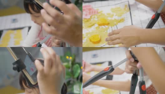 亚洲女孩拍摄视频，她的姐姐在家自制饼干，为病毒视频或TikTok在家，新一代的时尚生活理念。高清在线视频素材下载