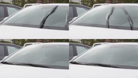 汽车挡风玻璃上的雨刷和清洗液。高清在线视频素材下载
