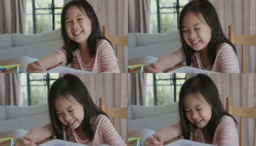 年轻的混血亚洲女孩在家上学，电子学习，新常态概念高清在线视频素材下载