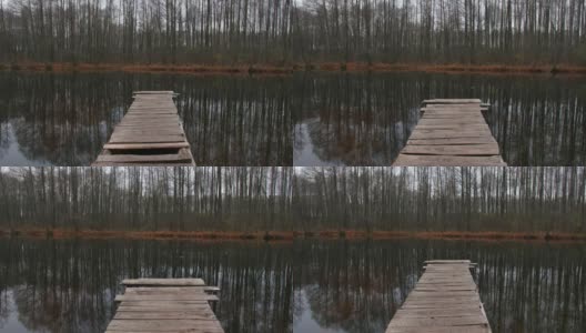 木栈桥上的池塘，倒影着树木高清在线视频素材下载