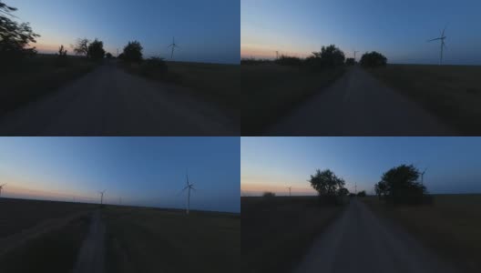 傍晚，FPV在风电场之间飞行高清在线视频素材下载