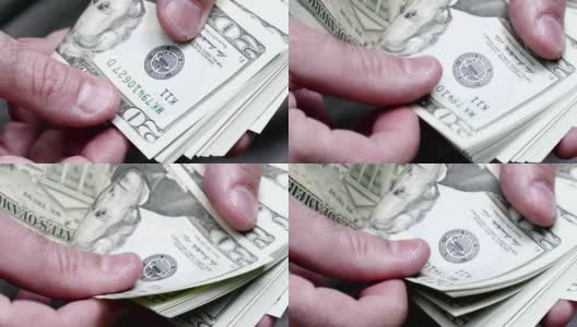 男子数着一叠20美元的钞票高清在线视频素材下载