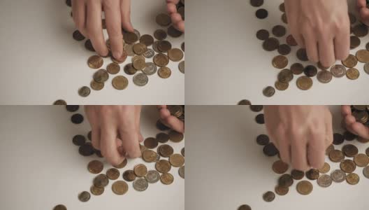 男人的手从堆里捡起硬币。慢动作高清在线视频素材下载