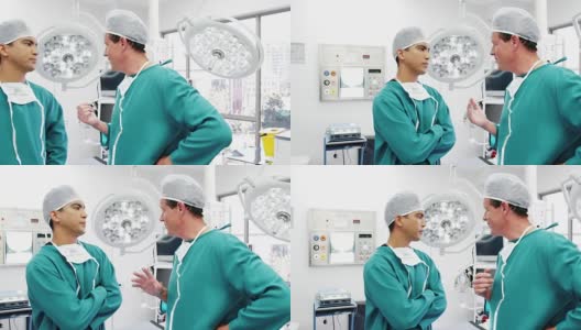 男性外科医生在手术室互相交流高清在线视频素材下载