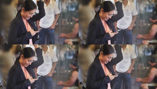 亚洲女性在火车上用智能手机使用社交媒体高清在线视频素材下载