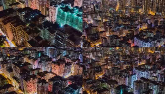夜间，无人机在香港九龙人口密集的地区上空飞行，在孟角区有许多住宅建筑，背景是香港中部。高清在线视频素材下载