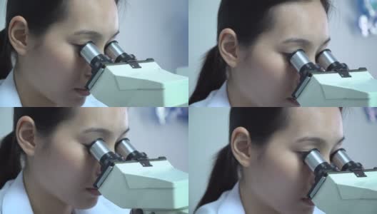 在实验室使用显微镜的医生高清在线视频素材下载