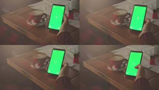男子用绿色屏幕的手机手持股票视频高清在线视频素材下载