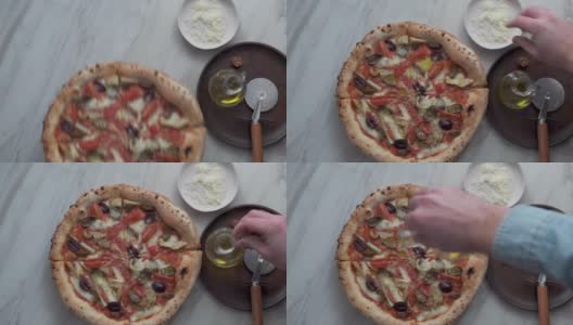 男子提供自制的朝鲜蓟和橄榄披萨高清在线视频素材下载