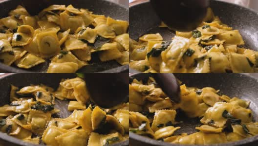慢动作，用黄油和鼠尾草在煎锅中搅拌和烹饪饺子面高清在线视频素材下载