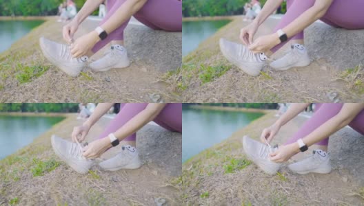 亚洲妇女在美丽的公园系运动鞋高清在线视频素材下载