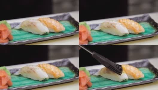 厨师用刷子在手握寿司上涂油高清在线视频素材下载