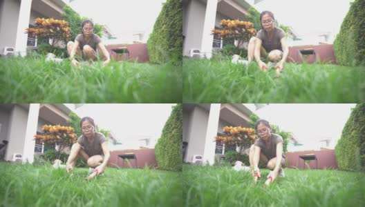 一位妇女在前院用花园剪刀修剪草坪高清在线视频素材下载