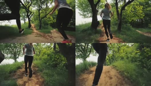 两个女孩在林中小路上跑，两个年轻女孩跑，后视镜，晨跑女孩，两个运动员跑高清在线视频素材下载