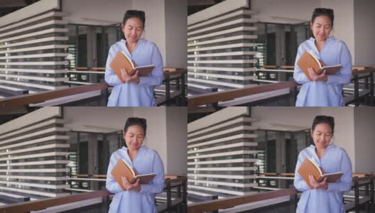 肖像的亚洲女商人与文件在户外办公大楼前高清在线视频素材下载