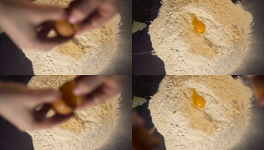 手在面粉上敲碎生鸡蛋，烘焙概念的慢动作高清在线视频素材下载