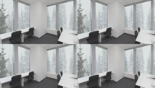 空荡荡的办公室，桌子上放着椅子和电话，窗外的森林里飘着雪花。背景板，色度键视频背景高清在线视频素材下载