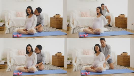 丈夫给怀孕的妻子按摩后在家训练瑜伽或锻炼，健康和怀孕的概念高清在线视频素材下载
