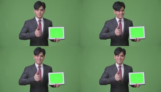 年轻英俊的亚洲商人使用数字平板电脑高清在线视频素材下载