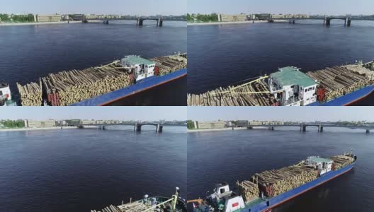 载着砍过的木头的驳船拖着碧水的大河高清在线视频素材下载