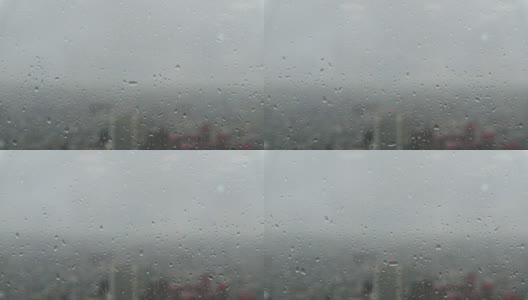 透过玻璃窗外的城市景观与雨滴在摩天大楼高清在线视频素材下载