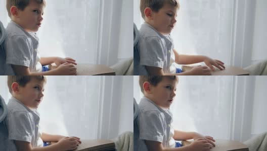 坐在窗台上看盲文的盲人孩子高清在线视频素材下载