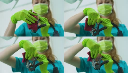 女牙医擦拭放大镜，专业设备，现代诊所高清在线视频素材下载