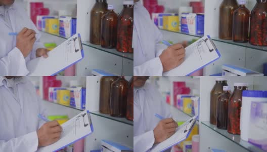 药剂师在检查货架上的药品，特写高清在线视频素材下载
