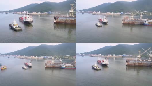 放大货轮和拖船在码头漂流的画面高清在线视频素材下载