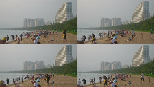 日落时分三亚市拥挤的海滩湾慢镜头全景4k海南中国高清在线视频素材下载