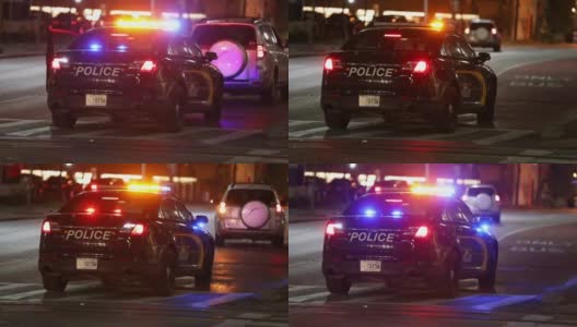 巴尔的摩城市街道和夜间警车灯。一名警察在公交专线上拦截了一辆不明车辆。马里兰高清在线视频素材下载