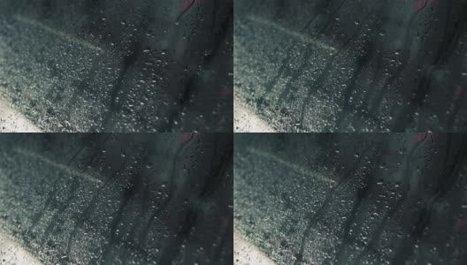 雨水滴在汽车的玻璃窗上慢慢地落下。高清在线视频素材下载