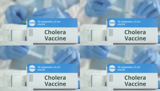 工作实验室助理旁边的桌子上放着霍乱疫苗安瓿瓶，盒子上有虚构的标志高清在线视频素材下载