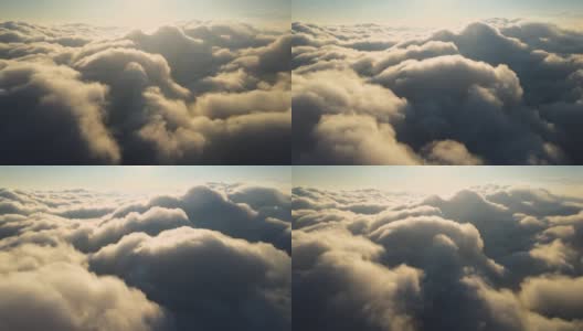 高空从飞机窗口俯瞰傍晚暴雨前形成的浓密蓬松的积云高清在线视频素材下载