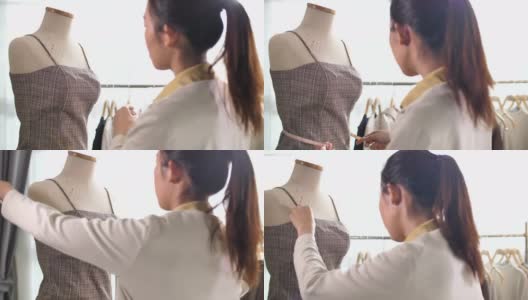 亚洲时装设计师，裁缝和裁缝调整衣服上裁减人体模型高清在线视频素材下载